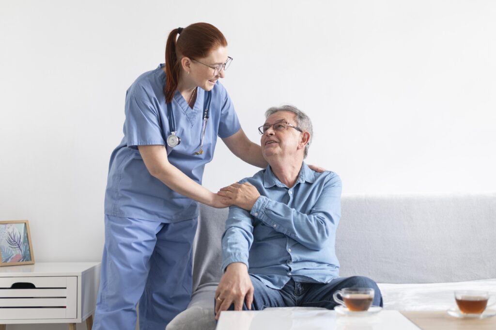 Specialist cancer nurse delivering IV infusion therapy to a patient at home